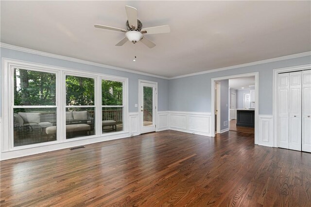 interior space with crown molding, visible vents, a ceiling fan, and dark wood-type flooring