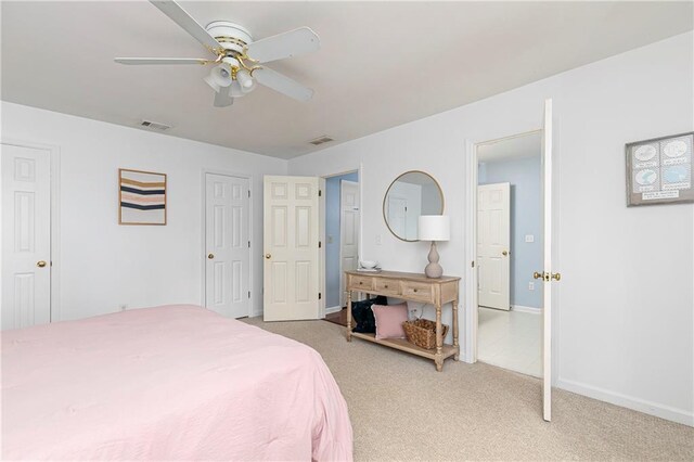 bedroom with carpet floors, baseboards, ceiling fan, and visible vents