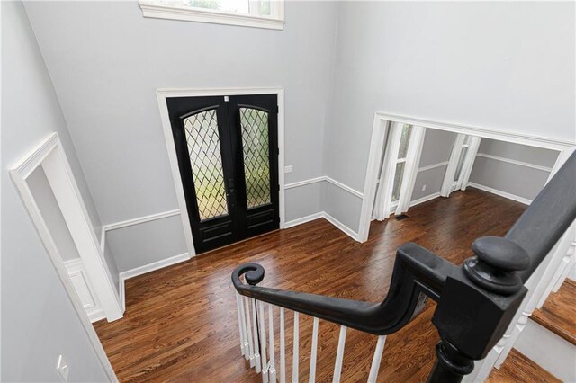 entryway with french doors, baseboards, and wood finished floors