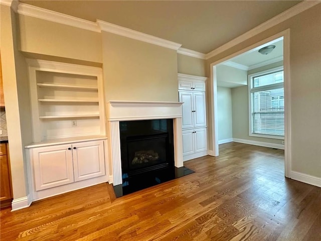 4875 Carre Way, Alpharetta, GA 30022 - unfurnished living room with ornamental molding, a fireplace with flush hearth, baseboards, dark wood finished floors, and built in features