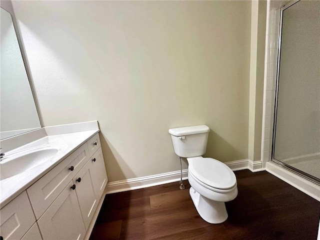 4875 Carre Way, Alpharetta, GA 30022 - bathroom with baseboards, wood finished floors, toilet, a shower stall, and vanity