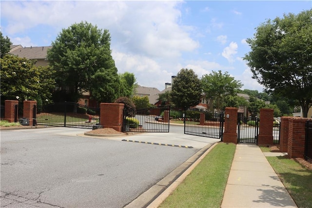 4875 Carre Way, Alpharetta, GA 30022 - view of asphalt road with a gate, a gated entry, curbs, and sidewalks