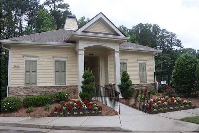 4875 Carre Way, Alpharetta, GA 30022 - view of front of property with stone siding, a chimney, and a shingled roof