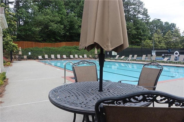 4875 Carre Way, Alpharetta, GA 30022 - community pool with view of wooded area and a patio area