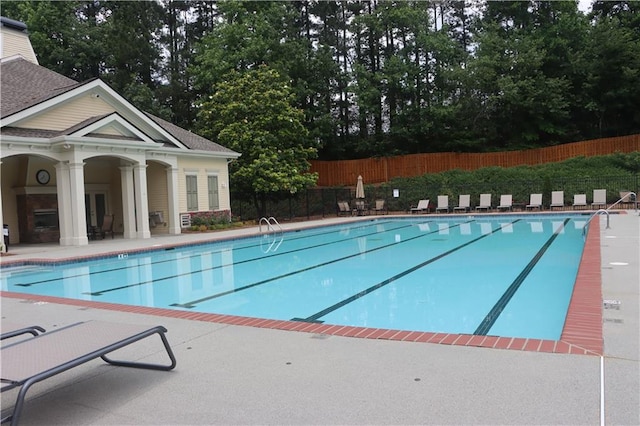 4875 Carre Way, Alpharetta, GA 30022 - community pool featuring a patio area and view of wooded area