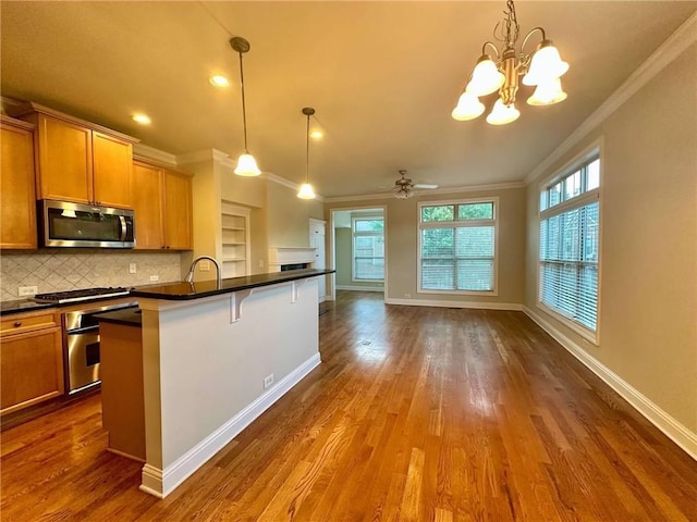 4875 Carre Way, Alpharetta, GA 30022 - kitchen with stainless steel appliances, ornamental molding, dark countertops, plenty of natural light, and open floor plan