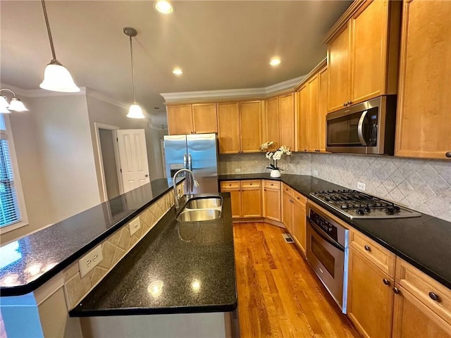 4875 Carre Way, Alpharetta, GA 30022 - kitchen with appliances with stainless steel finishes, a sink, ornamental molding, wood finished floors, and backsplash