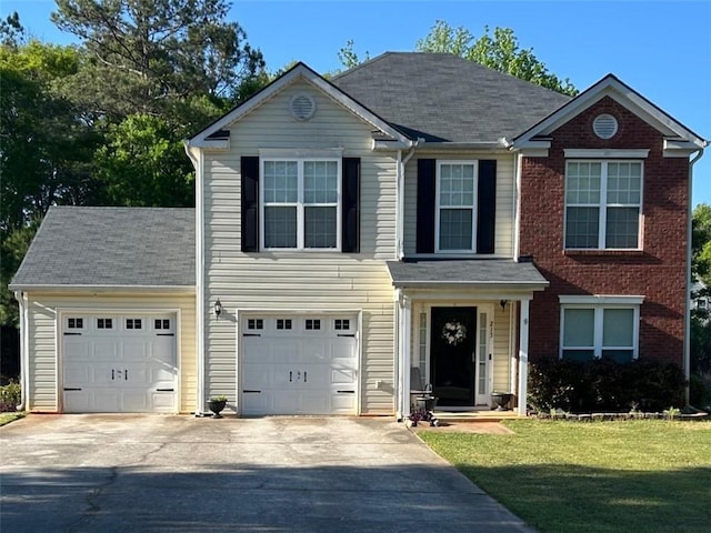 view of front of property with a front lawn and concrete driveway