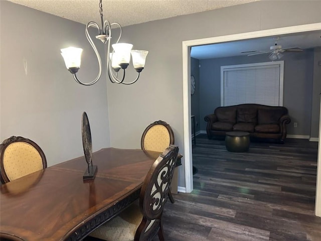 dining space featuring wood finished floors, a textured ceiling, baseboards, and ceiling fan with notable chandelier