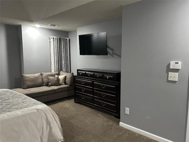 bedroom featuring dark colored carpet, visible vents, and baseboards