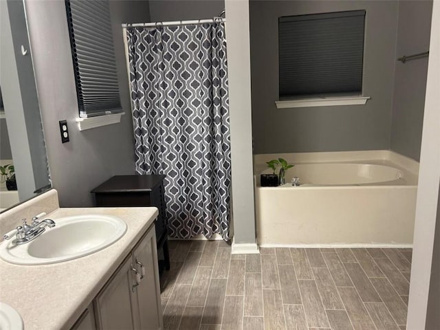 bathroom featuring a bath, vanity, wood tiled floor, and a shower with curtain