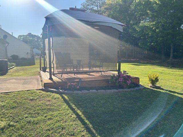 view of yard featuring a wooden deck and central AC