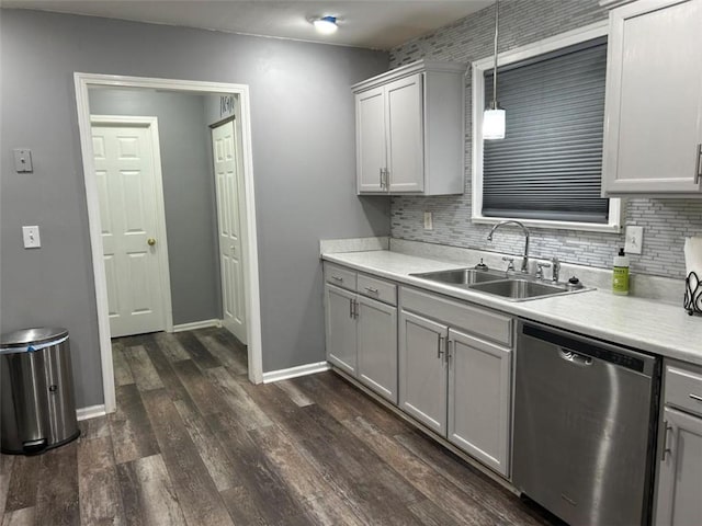 kitchen with dishwasher, backsplash, a sink, and light countertops