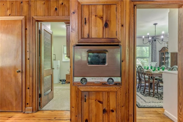 103 White Cir, Rockmart, GA 30153 - kitchen with a chandelier, light wood-type flooring, brown cabinets, and water heater