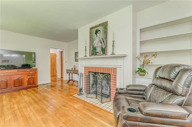 103 White Cir, Rockmart, GA 30153 - living area featuring light wood finished floors, a brick fireplace, and built in shelves