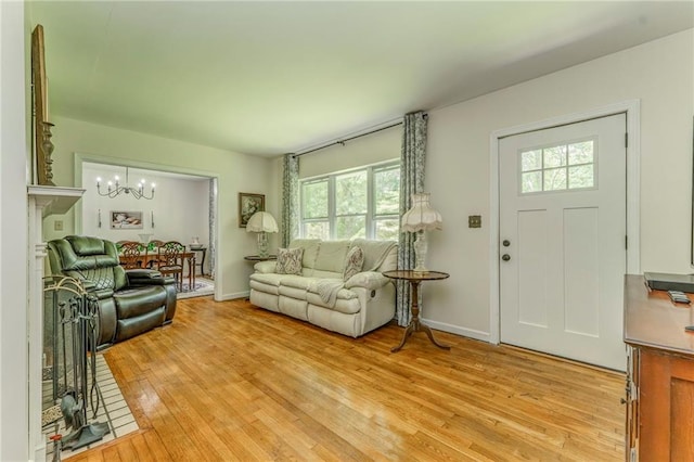 103 White Cir, Rockmart, GA 30153 - living room featuring a chandelier, healthy amount of natural light, light wood finished floors, and baseboards