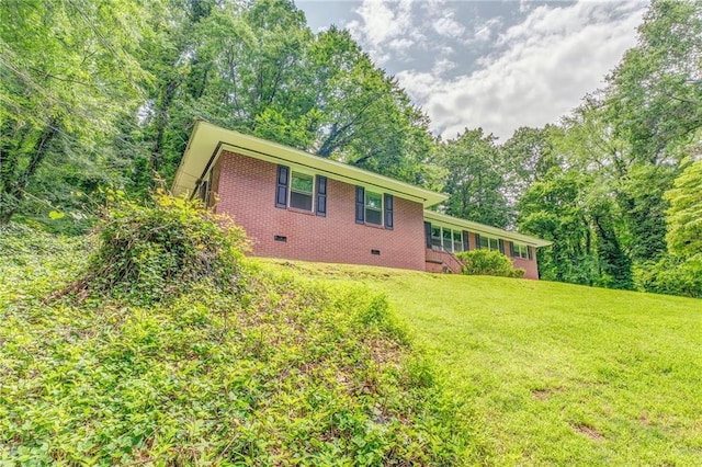 103 White Cir, Rockmart, GA 30153 - rear view of house featuring crawl space, brick siding, a yard, and a view of trees