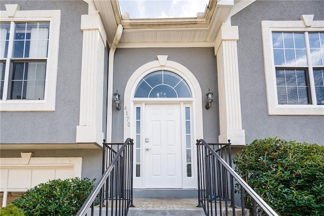 view of exterior entry with stucco siding