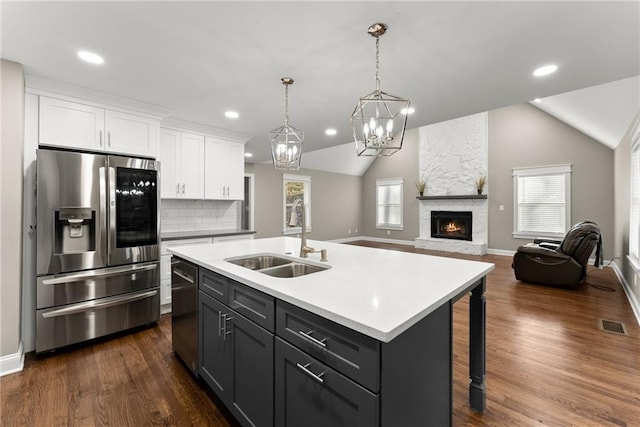 4635 Dawsonville Hwy, Gainesville, GA 30506 - kitchen featuring vaulted ceiling, white cabinets, stainless steel appliances, and a sink