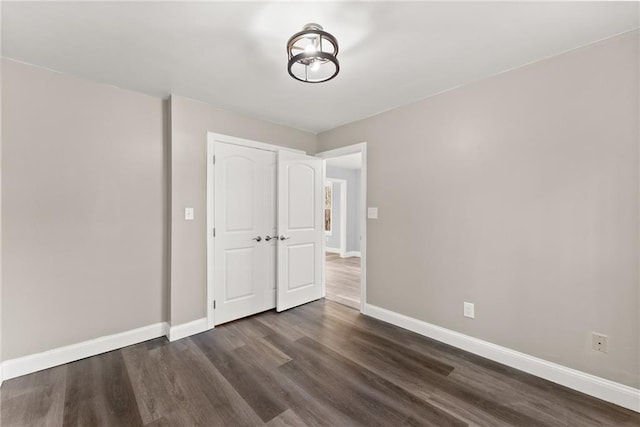 4635 Dawsonville Hwy, Gainesville, GA 30506 - unfurnished bedroom with dark wood finished floors, baseboards, and a closet