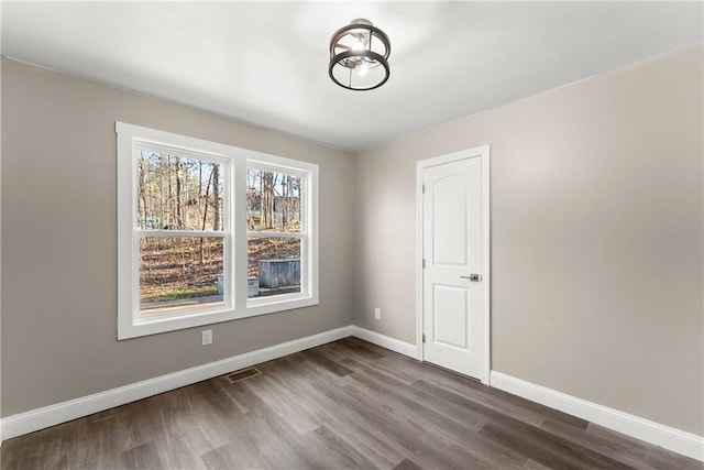 4635 Dawsonville Hwy, Gainesville, GA 30506 - unfurnished room featuring visible vents, baseboards, and dark wood-style flooring