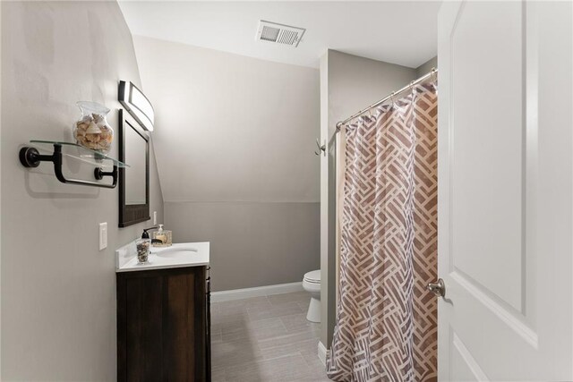 4635 Dawsonville Hwy, Gainesville, GA 30506 - bathroom with visible vents, baseboards, toilet, lofted ceiling, and vanity