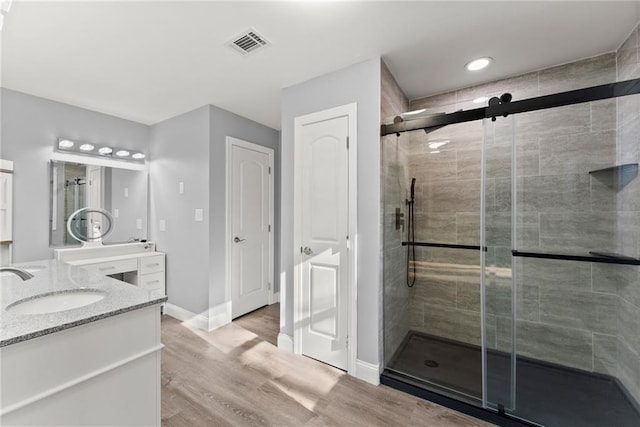 4635 Dawsonville Hwy, Gainesville, GA 30506 - full bathroom featuring visible vents, a stall shower, wood finished floors, baseboards, and vanity