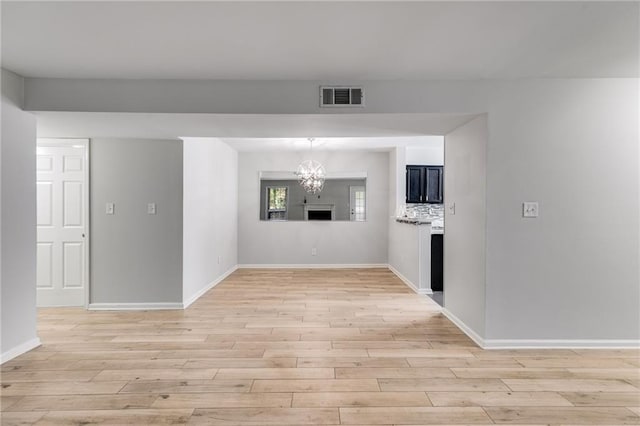 2135 N Forest Trl, Dunwoody, GA 30338 - unfurnished room featuring light wood-style floors, a chandelier, and baseboards
