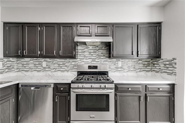 2135 N Forest Trl, Dunwoody, GA 30338 - kitchen featuring appliances with stainless steel finishes, under cabinet range hood, backsplash, and light stone counters