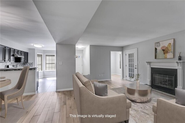 2135 N Forest Trl, Dunwoody, GA 30338 - living area with light wood finished floors, baseboards, and a glass covered fireplace