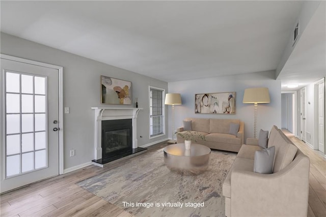 2135 N Forest Trl, Dunwoody, GA 30338 - living area featuring wood finished floors, a glass covered fireplace, and baseboards