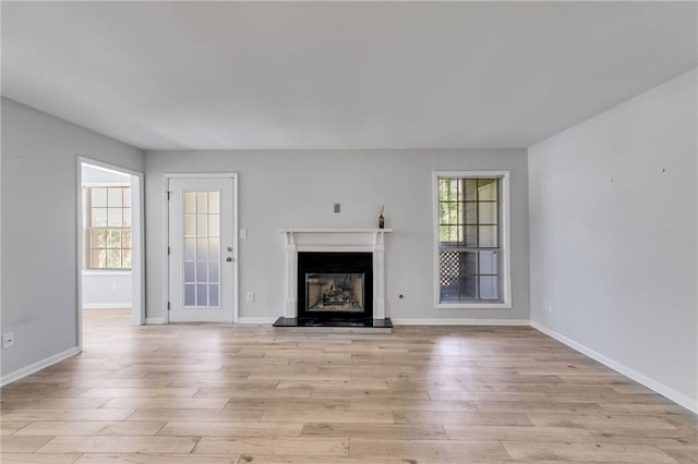 2135 N Forest Trl, Dunwoody, GA 30338 - unfurnished living room with light wood finished floors, baseboards, and a fireplace with raised hearth