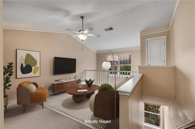 living room featuring vaulted ceiling, ceiling fan, and crown molding