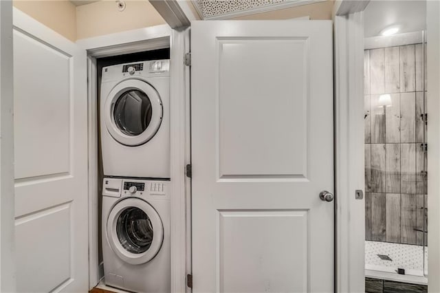 clothes washing area featuring stacked washer / drying machine