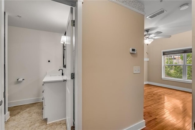 bathroom featuring sink, hardwood / wood-style flooring, and ceiling fan