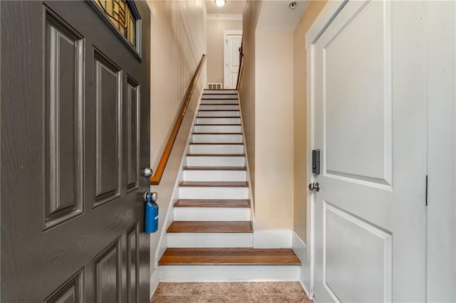 staircase with tile patterned floors