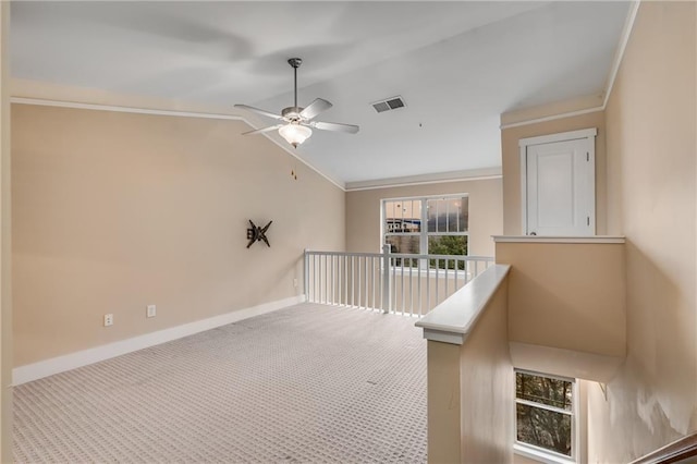 interior space with crown molding, lofted ceiling, and carpet flooring