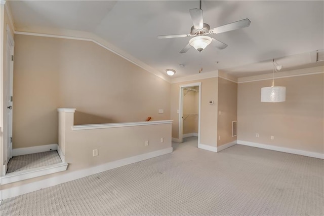 spare room featuring ceiling fan, light colored carpet, and lofted ceiling