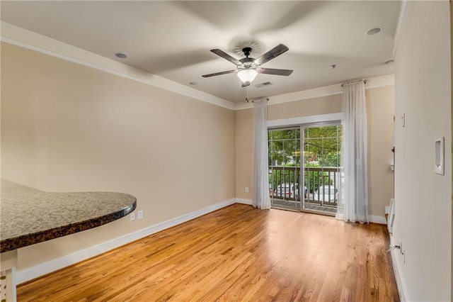 unfurnished room featuring ornamental molding, light hardwood / wood-style floors, and ceiling fan