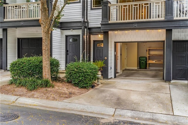 doorway to property with a garage and a balcony