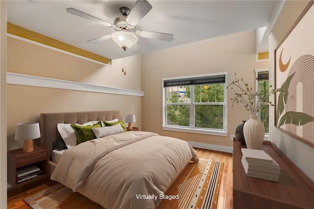 bedroom featuring ceiling fan and hardwood / wood-style floors