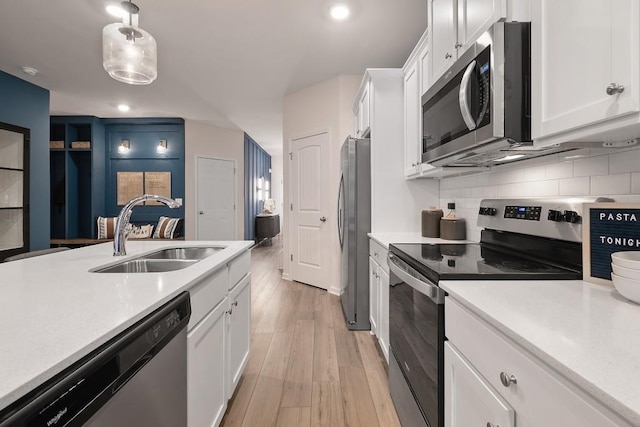 104 Chapel Hill Pkwy, Newnan, GA 30263 - kitchen featuring white cabinets, light countertops, appliances with stainless steel finishes, and a sink