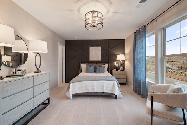 104 Chapel Hill Pkwy, Newnan, GA 30263 - bedroom with a notable chandelier, baseboards, visible vents, an accent wall, and light colored carpet