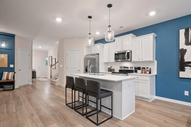 104 Chapel Hill Pkwy, Newnan, GA 30263 - kitchen featuring a breakfast bar area, stainless steel appliances, decorative backsplash, light countertops, and an island with sink