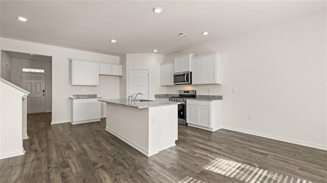 1316 Village Brook Dr, Dacula, GA 30019 - kitchen featuring stainless steel appliances, dark wood-style flooring, a center island with sink, white cabinetry, and recessed lighting