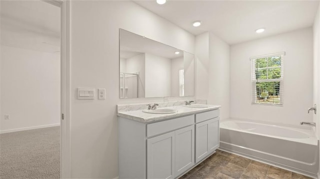 1316 Village Brook Dr, Dacula, GA 30019 - bathroom featuring double vanity, a bath, and recessed lighting