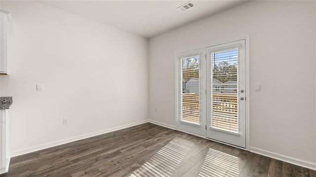 1316 Village Brook Dr, Dacula, GA 30019 - unfurnished dining area featuring dark wood-type flooring and baseboards