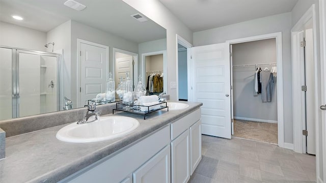 1316 Village Brook Dr, Dacula, GA 30019 - full bath featuring double vanity, a spacious closet, a shower stall, and recessed lighting