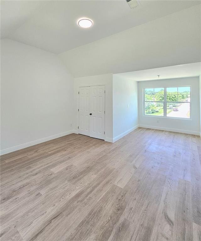 681 Burtons Cv, Hampton, GA 30228 - unfurnished room featuring baseboards, vaulted ceiling, and light wood-style flooring