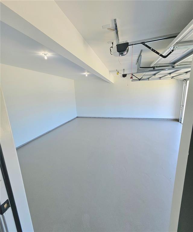 681 Burtons Cv, Hampton, GA 30228 - garage featuring a garage door opener